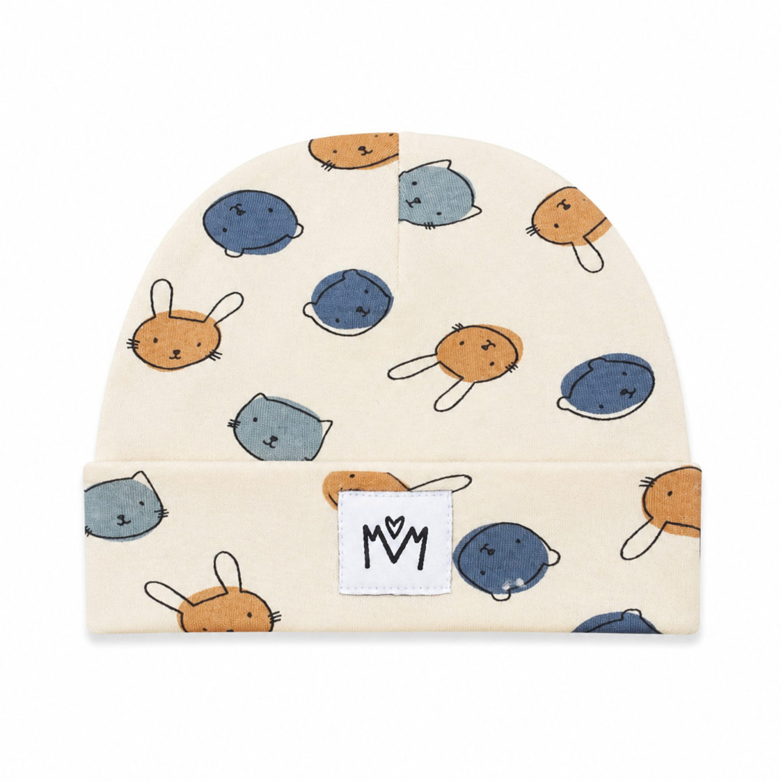 A cream-colored baby beanie hat featuring a playful pattern of cartoon animal faces in blue, gray, and orange. The hat has a folded cuff with a white fabric patch displaying the 'M M' logo.