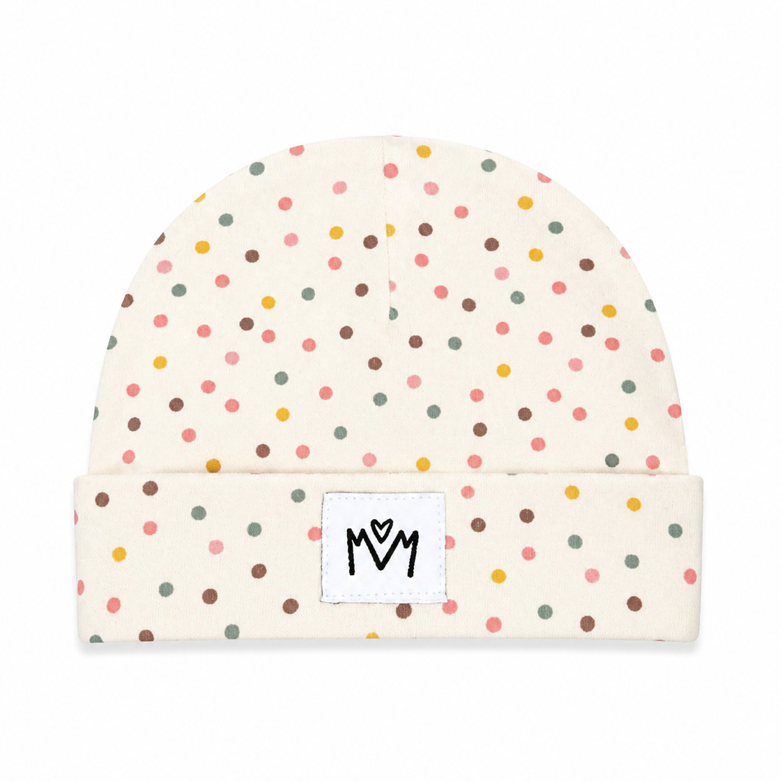 A cream-colored baby beanie hat with a colorful polka dot pattern in pink, yellow, green, and brown, featuring a white square patch on the folded cuff with a black embroidered 'M' logo.