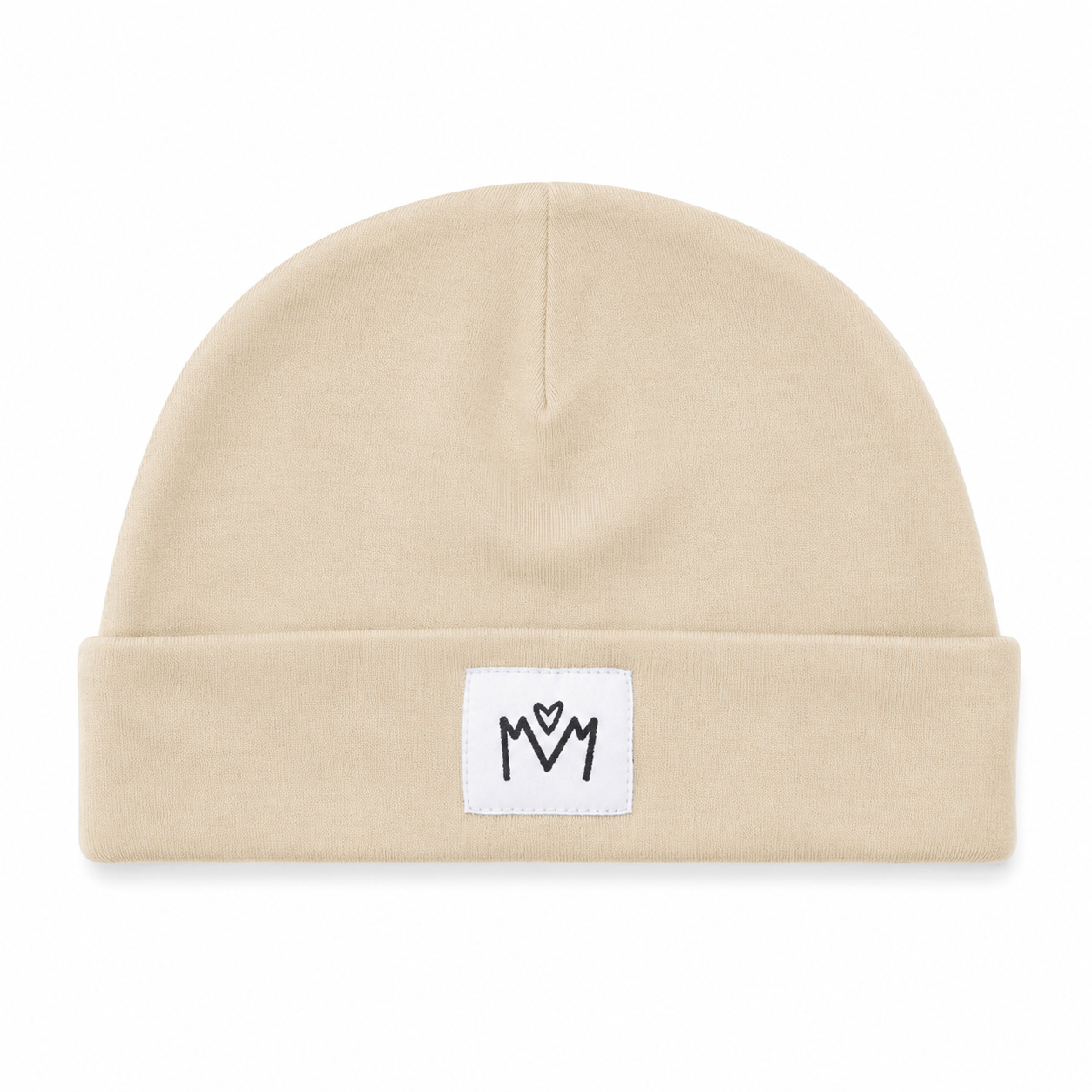 A beige knit beanie hat with a folded cuff, featuring a small white square patch on the front with a black embroidered 'M' logo.