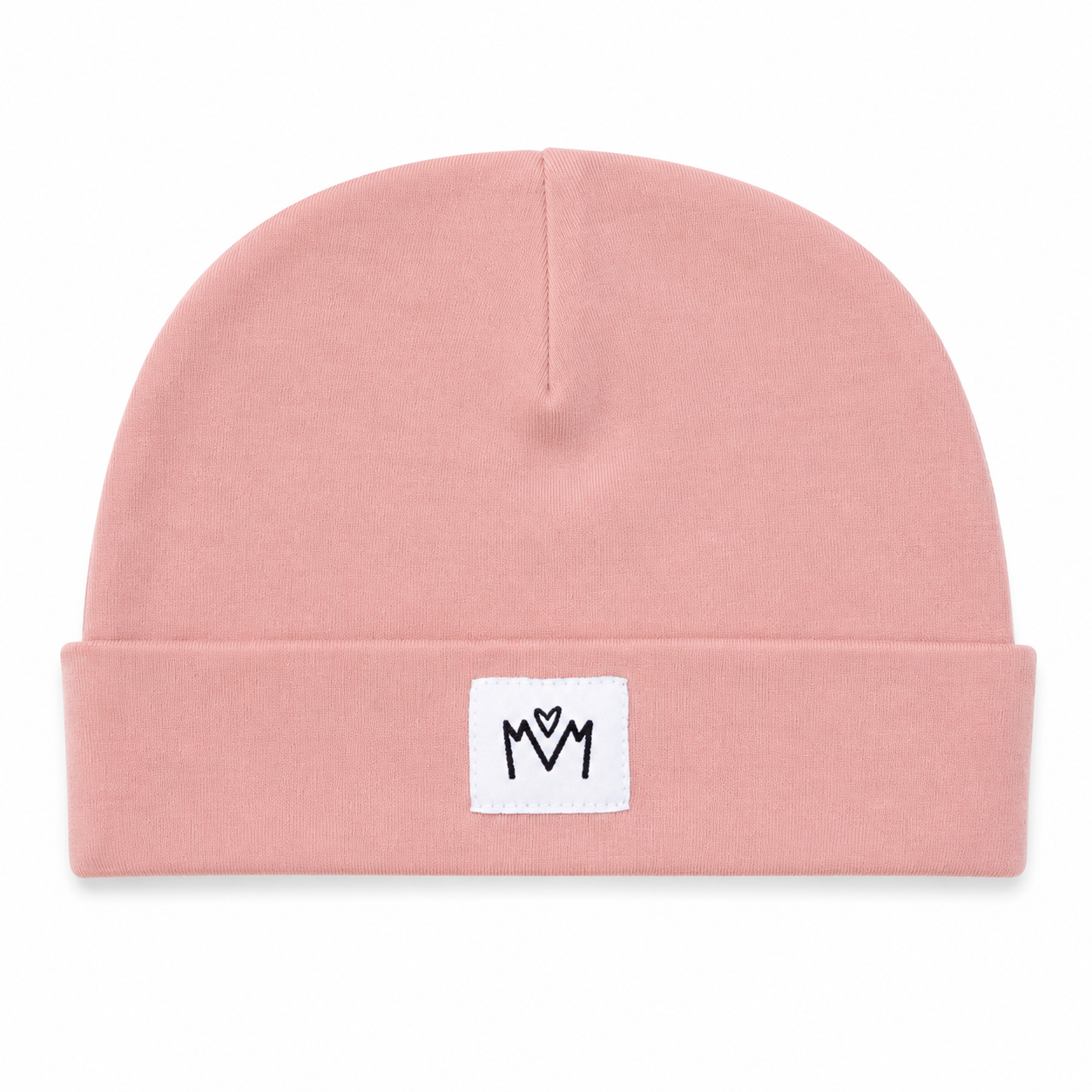 A dusty pink knit beanie hat with a folded cuff, featuring a small white square patch on the front with a black embroidered 'M' logo.