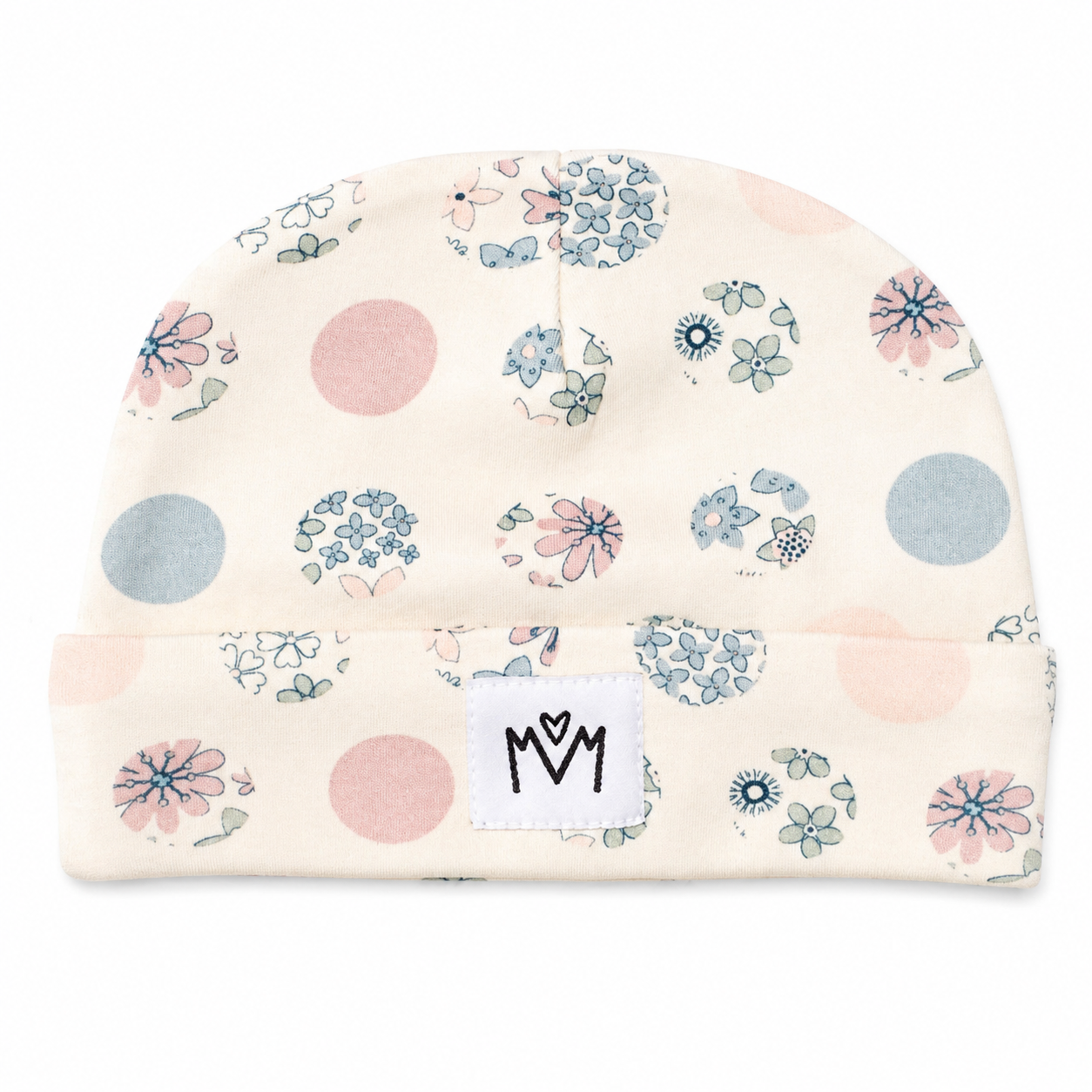 A cream-coloured knit beanie hat with a blue and pink floral pattern, a matching bib, and a small white patch that says 'MM' in black letters.