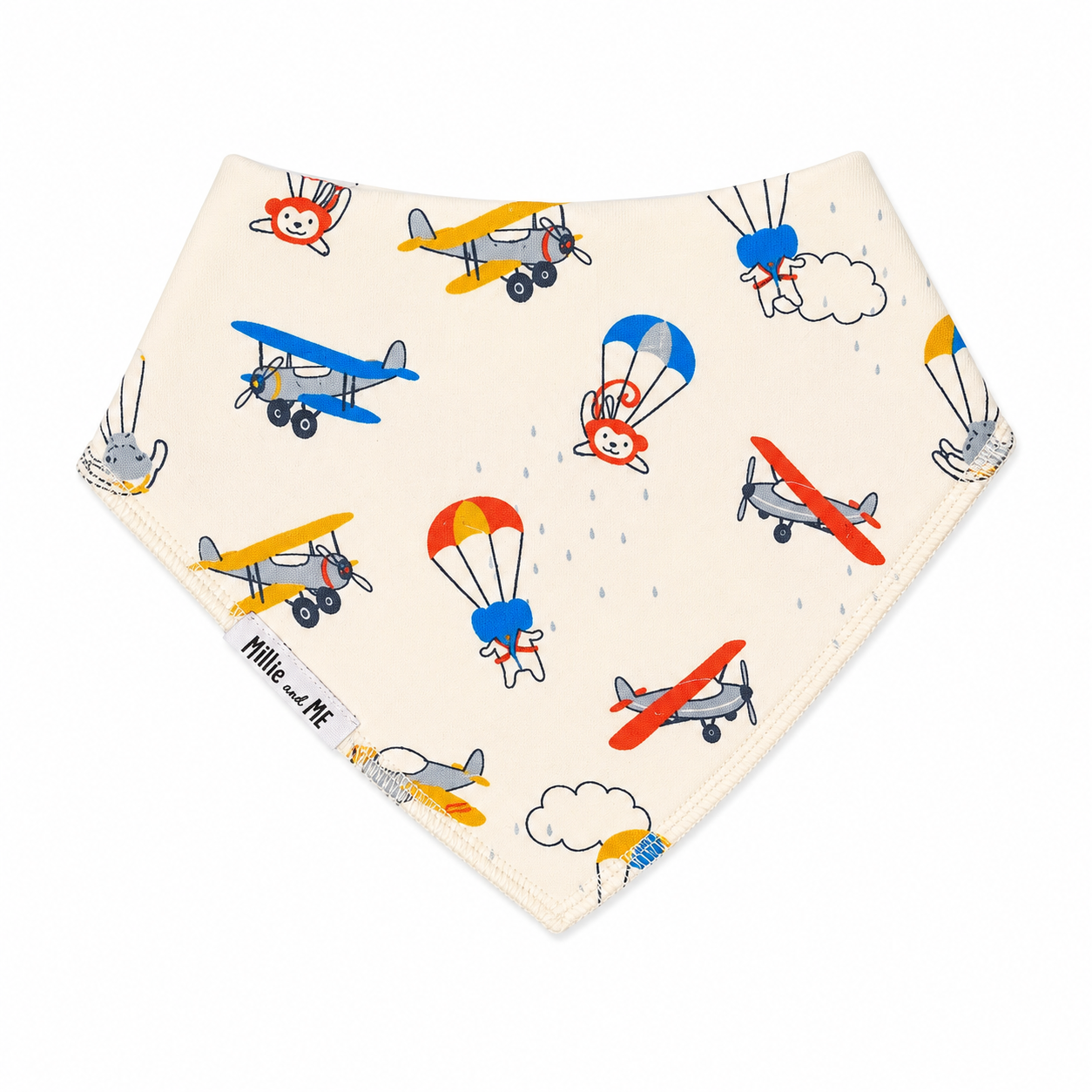 A triangular baby bandana bib in cream with a colourful pattern of vintage airplanes and hot air balloons, featuring the 'Mille and Me' brand label.