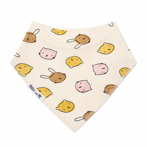 Millie and Me Bandana Bib in Bunny Face Dots Sandstone – organic cotton baby bib with an all-over cute animal faces print featuring bunnies, cats and bears in sandstone, yellow and pink on a cream background, Millie and Me label detail