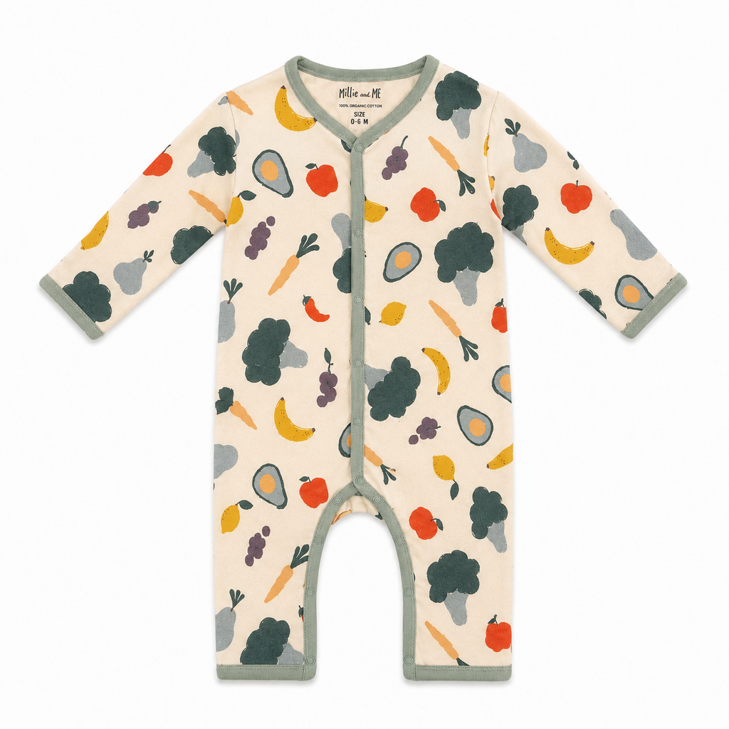 A baby long-sleeve footless romper in cream with a colorful fruit and vegetable print, featuring sage green trim and a snap closure.