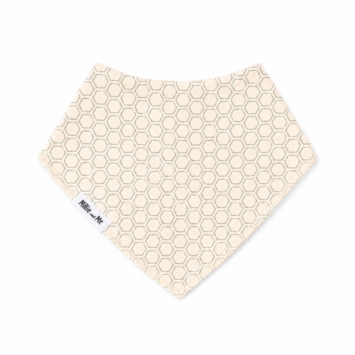 A triangular baby bandana bib with a cream and light blue honeycomb pattern and a white woven label on the side, displayed on a clean white background.