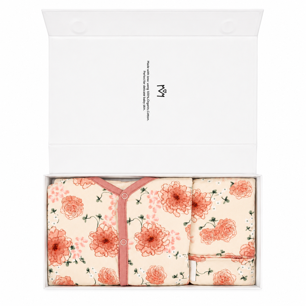 Millie and Me New Baby Gift Box open to reveal floral watercolour organic cotton romper, bib and hat set