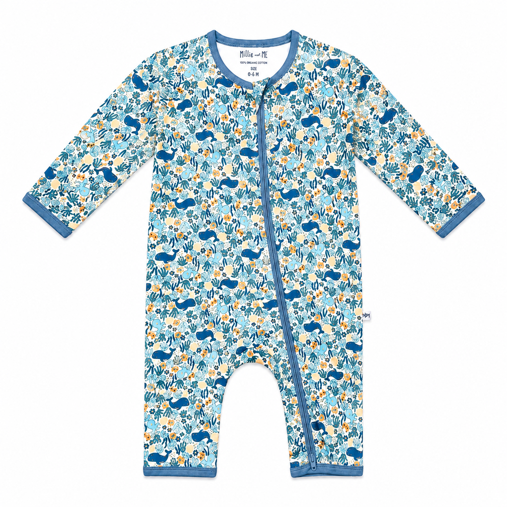 A baby long-sleeve footless one-piece sleeper with a blue, yellow, and white woodland animal pattern, featuring a blue snap closure down the front.