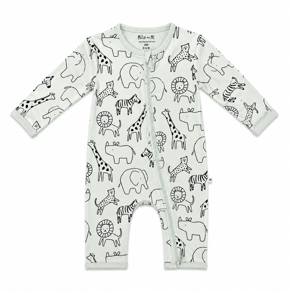 A baby long-sleeve footless zip-up sleeper in off-white, featuring an all-over black line art print of safari animals including giraffes, zebras, lions, and elephants. The brand 'Mila + Mi' is printed inside the collar.