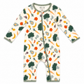 A baby long-sleeve footless one-piece sleeper with an all-over vegetable print on an off-white background. The print features green broccoli, yellow bananas, orange carrots, and red apples.