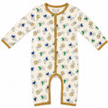 A baby long-sleeve footless one-piece sleeper with a cream background, featuring a playful print of astronauts, rockets, and planets in blue, green, and gold. It has a gold trim along the collar, armholes, cuffs, and snap-button front.