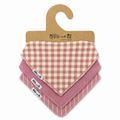 Three baby bandana bibs from Millie and Me on a brown cardboard hanger. The top bib features a dusty pink and cream gingham check pattern, while the bottom two are solid dusty pink with one featuring thin cream vertical stripes.