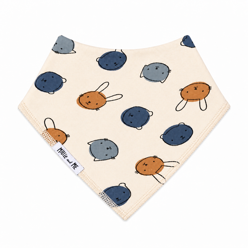 Millie and Me Bunny Face Dots Citadel Bandana Bib, featuring cute bunny face motifs in soft blue and warm brown on a cream background, made from 100% organic cotton with adjustable nickel-free poppers for babies from newborn to 24 months.