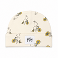 A cream-colored knit beanie hat featuring an all-over print of white rabbits riding yellow bicycles. A white rectangular patch on the folded cuff displays a black stylized 'MM' logo.