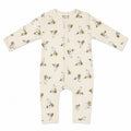 An infant long-sleeve footless one-piece romper in cream, featuring an all-over print of cartoon rabbits riding yellow bicycles. The romper has a center front zipper and is photographed flat against a solid white background.