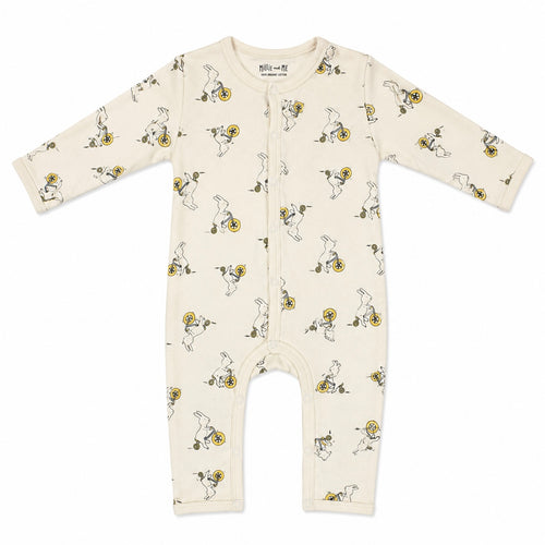 An infant long-sleeve footless one-piece romper in cream, featuring an all-over print of cartoon rabbits riding yellow bicycles. The romper has a center front zipper and is photographed flat against a solid white background.