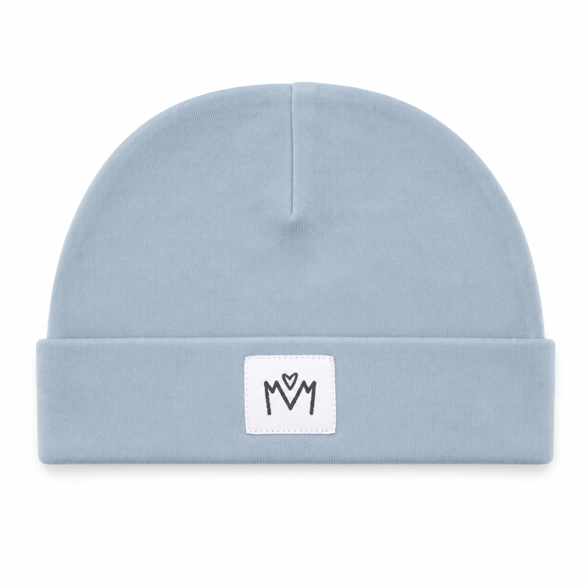 A light blue knit beanie hat with a folded cuff, featuring a small white square patch on the front with a black embroidered 'M' logo.