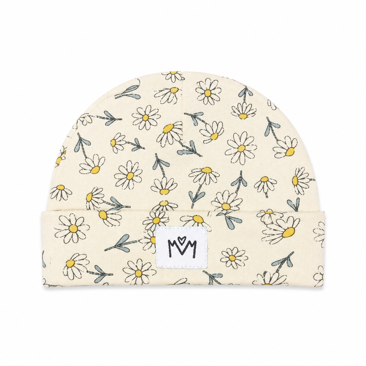 A cream-colored knit beanie hat with a repeating pattern of hand-drawn white daisies with yellow centers and gray-green stems. It features a white fabric patch on the folded cuff with the letters 'MOM' in black.