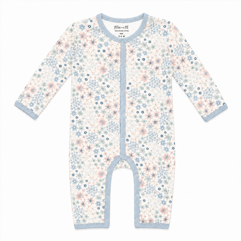 A long-sleeve baby footless one-piece sleeper with a delicate floral print in light blue, pink, and navy on an off-white background, featuring light blue trim.