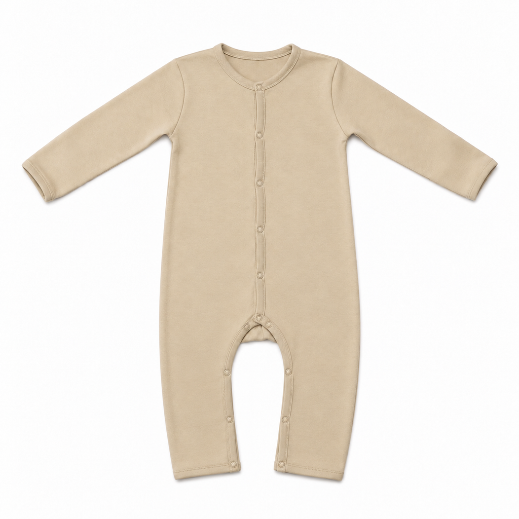 A long-sleeve baby footless one-piece sleeper in a light beige color, featuring a snap-button closure down the front and along the crotch, laid flat on a white background.