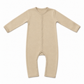 A long-sleeve baby footless one-piece sleeper in a light beige color, featuring a snap-button closure down the front and along the crotch, laid flat on a white background.