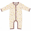 A baby long-sleeve footless sleeper with a cream base, brown trim, and a pattern of small yellow, brown, and pink dots and lines, shown flat on a white background.
