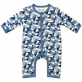 A baby long-sleeve footless romper with a geometric triangle pattern in shades of blue and cream, featuring a blue snap-button placket and collar.