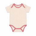 A short-sleeve baby bodysuit with a light pink and white honeycomb, featuring dusty rose pink trim on the collar, sleeve cuffs, and crotch.