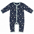 A baby long-sleeve footless one-piece sleeper in navy blue with a celestial print of stars, moons, and shooting stars, finished with light blue trim.