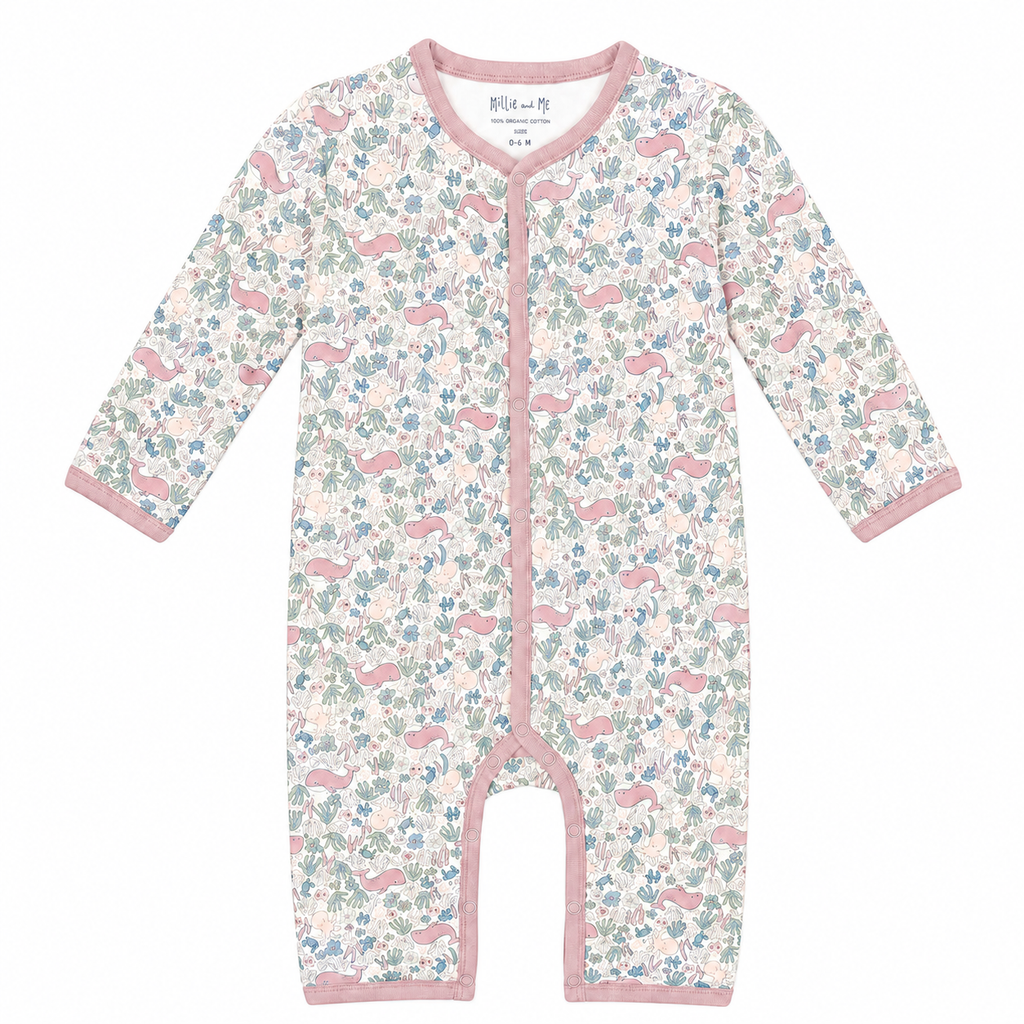 A baby long-sleeve footless sleeper with a pink, blue, and green woodland animal print on a cream background, featuring pink trim and snap closures down the front.