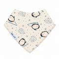 A triangular baby bib with a penguin and icy pattern on a cream background, featuring a light blue fabric brand tag that reads 'Millie and Me'.