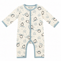 A baby long-sleeve footless one-piece sleeper with a penguin and ice motif on a cream background, featuring light blue trim and snap closures down the front.