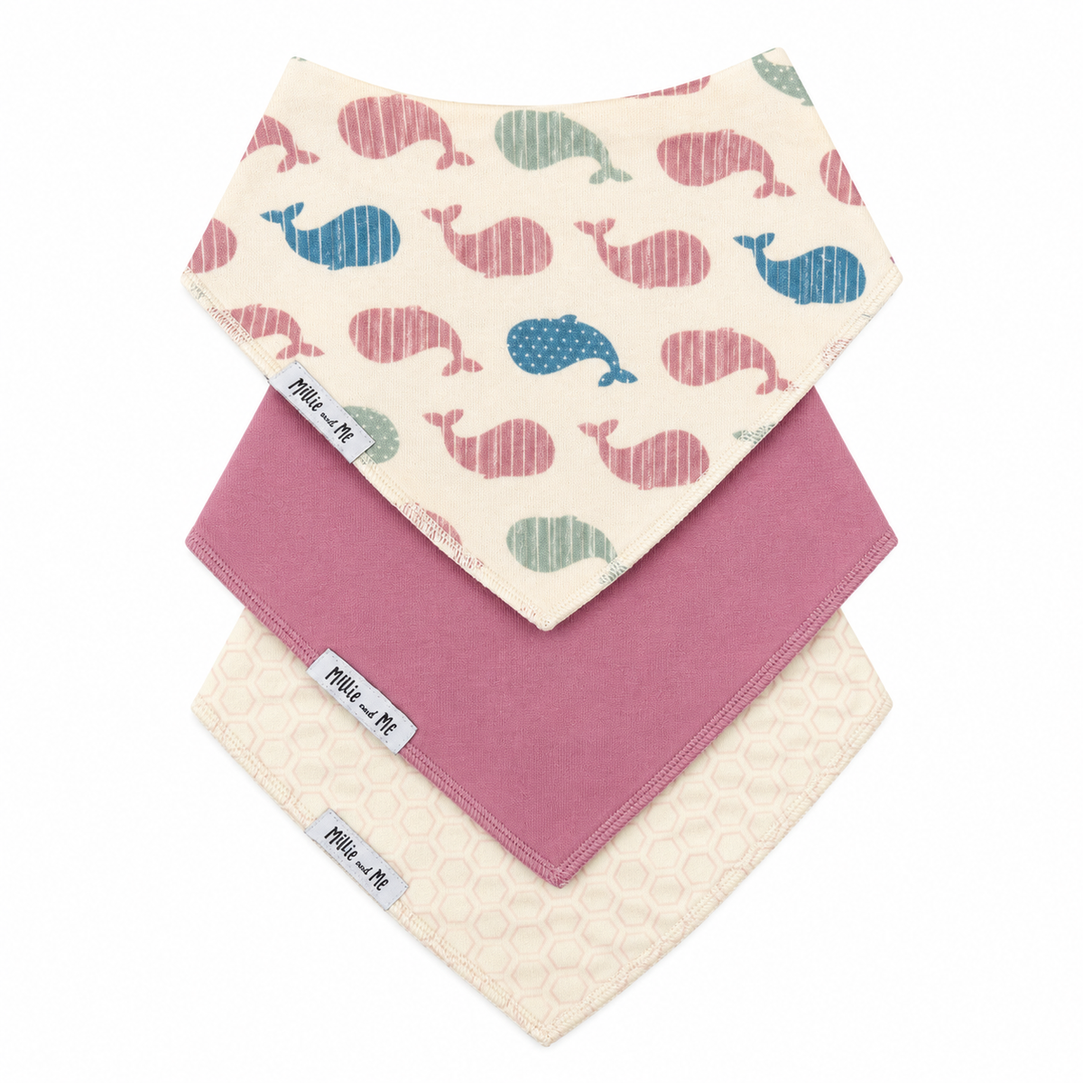 Three baby bandana bibs from the brand Millie & Me, stacked diagonally on a white background. The top bib features a cream base with a pattern of pink and blue whales.