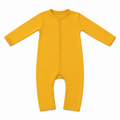 A long-sleeve baby romper in solid mustard yellow, featuring a snap-button front closure and leg openings, laid flat on a white background.