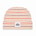 A cuffed knit beanie hat featuring horizontal wavy stripes in shades of coral red, dusty rose, and dark brown on a warm cream background. A small white rectangular patch on the front cuff displays the black hand-drawn logo 'MM'.