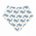 A triangular baby bandana bib with a repeating pattern of light blue whales on an off-white background. The brand name 'Millie and Me' is printed on a small white label near the bottom left corner.