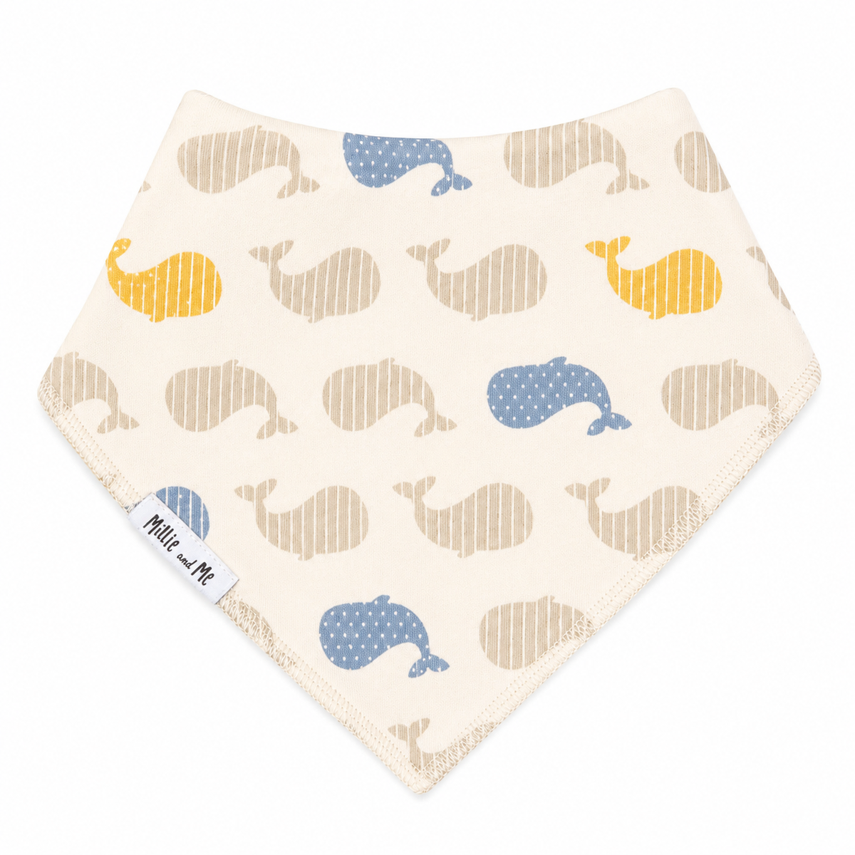 A triangular baby bandana bib with an off-white background, featuring a pattern of stylized whales in blue and mustard yellow. The bib has a white fabric tag on the lower left edge with the text 'Millie and Me'.